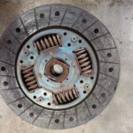 Badly worn clutch plate showing excessive wear undergoing replacement at GP Motor Works