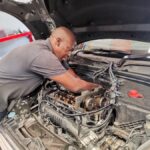 Mini Cooper Technician fitting camshaft tool to ensure timing is precise at GP Motor Works